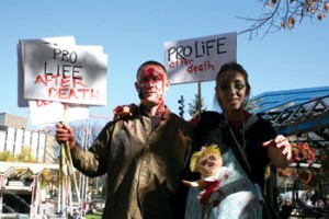 Photo by Vanessa Gillard. These zombie “pro-lifers” ambled through the streets of downtown Calgary, spreading their indoctrination and following roadsigns. 