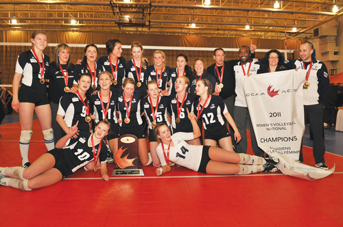 Photo courtesy of David Connell.  The Mount Royal University Cougars women’s volleyball team celebrates its first-ever CCAA national volleyball championship March 12 in Saint John, New Brusnwick. The Cougars defeated Vancouver Island University three games to two in the title contest. 
