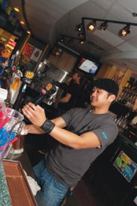 Photos by Bryan Weismiller.  Bartender Markus Tolentino pours a pint of Wild Rose WRaspberry Ale in the Liberty Lounge. 