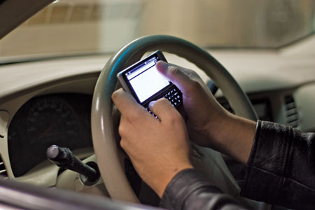 Alberta's new distracted driving law, which came into effect on Sept. 1, is designed to encourage drivers to focus on the road. Photo illustration: Rachel Frey